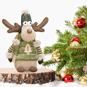 Adorable Christmas reindeer plush toy in green vest on wooden base for holiday decor