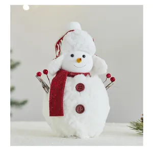 Close-up view of a cute plush Christmas snowman ornament with red scarf and knit hat
