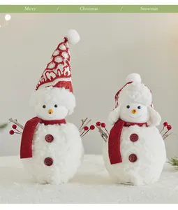 Two festive plush Christmas snowman figurines with red scarves and berry twig arms