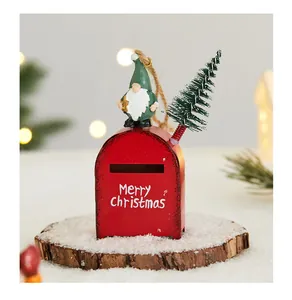 Close-up detail of a red iron Christmas mailbox ornament featuring a gnome and tree