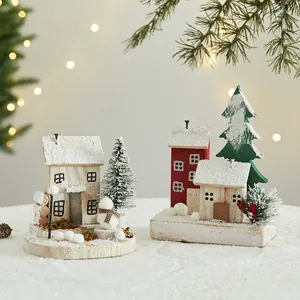 Handcrafted wooden Christmas house ornaments featuring fake snow and mini trees