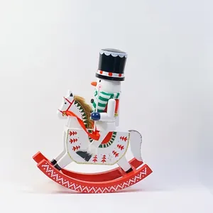 Close-up of a festive wooden nutcracker snowman riding a red rocking horse