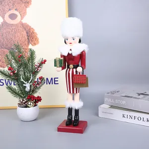 Detailed shot of wooden female nutcracker soldier figurine with white fur hat