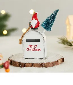 Detailed macro shot of white iron Christmas mailbox ornament with gnome and tree