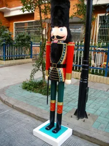 Large 1.8m wooden nutcracker soldier standing on a white base outdoors for Christmas