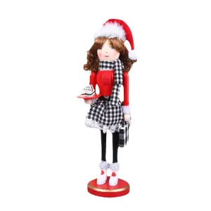 Decorative wooden Christmas nutcracker female doll in Santa hat and plaid outfit