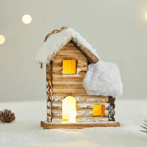 Rustic wooden Christmas cabin ornament with warm LED lights and snowy roof detail