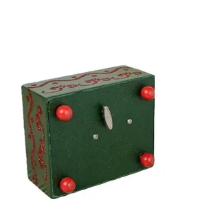 Green Nutcracker music box base with manual wind-up key and red spherical feet