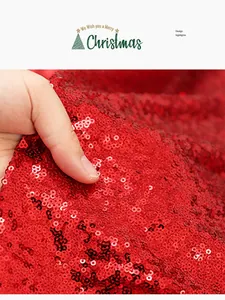 Macro view of glittering red sequins on a festive Christmas table runner fabric