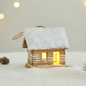Wooden glowing Christmas cabin ornament featuring a snowy roof and warm interior light