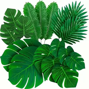 Artificial green monstera and palm leaves set for tropical Hawaii party table decor
