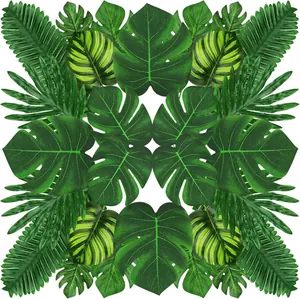 Symmetrical arrangement of artificial green Monstera leaves and palm fronds pattern