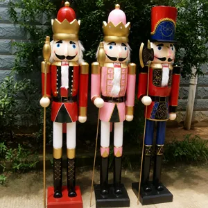 Three 1.8m large wooden Christmas nutcracker soldiers standing outdoors in a garden