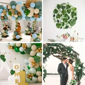Simulated monstera and palm leaves in jungle theme party balloon arch and wedding decor