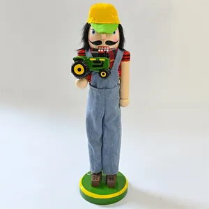 Detailed view of a farmer nutcracker soldier doll holding a green tractor model