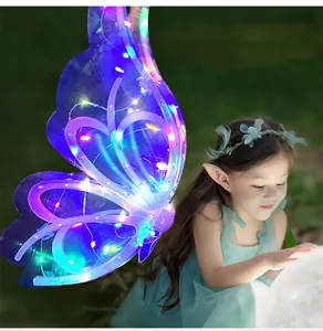 Close-up detail view of glowing LED butterfly wings on a child model in fairy theme