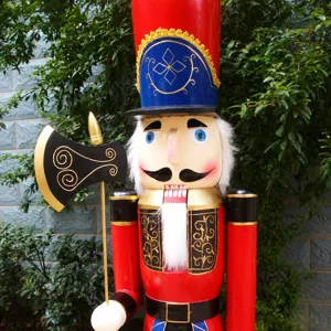 Detailed view of a large 1.8m wooden nutcracker soldier holding a black axe