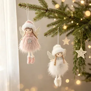 Detalle de ángeles de Navidad de felpa con alas brillantes en un pino