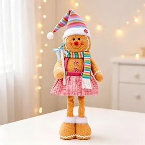 Close-up view of a plush gingerbread girl ornament with pink skirt and telescopic legs