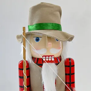 Close-up of a rustic fisherman nutcracker soldier figure with fabric hat and rod