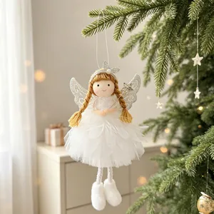 Close-up detail of a white fabric Christmas angel ornament with glitter wings on a tree.