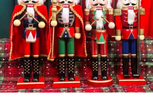 Close-up detail of four traditional 38cm wooden nutcracker soldiers in festive uniforms