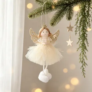 Adorable fabric Christmas angel ornament with glitter wings hanging on a pine tree
