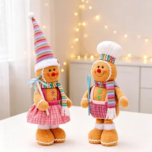 Pair of Christmas gingerbread man plush ornaments in pink plaid skirt and chef hat