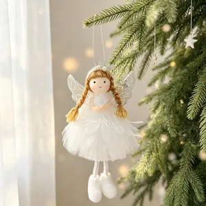 Close-up of a white fabric Christmas angel ornament with glitter wings and feather skirt