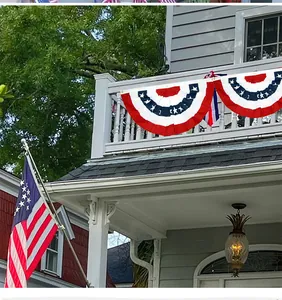 Detailed view of American flag pleated bunting hanging on a white house balcony.