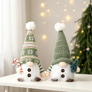 Close-up of plush Christmas gnomes with glowing LED lights and knitted hats