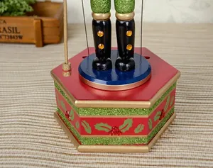 Detailed view of a green glitter nutcracker wind-up musical box base for Christmas decor