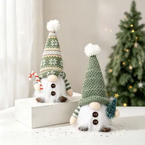 Pair of glowing green knitted Christmas gnomes with candy cane and tree decor.