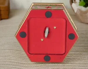 Bottom view of a Nutcracker wind-up mechanical music box with silver key