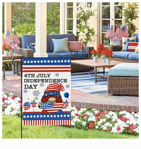 Detail of Independence Day garden flag with cute gnome in an outdoor patio setting