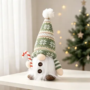 Close-up of a green knitted LED Christmas gnome decoration on a table