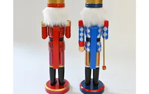 Back view of two 38cm wooden nutcracker soldier figurines with colorful patterns