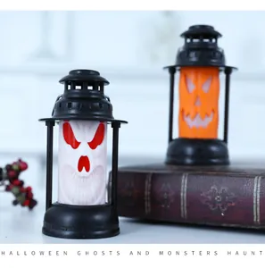 Detailed view of spooky white ghost and orange pumpkin Halloween lanterns on a table