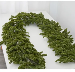 Detailed macro view of artificial green pine needle garland for festive Christmas decor