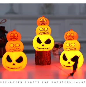 Glowing three-tier Halloween pumpkin decorative ornaments with spooky faces on display