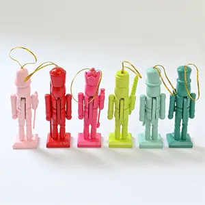Six colorful 13cm wooden nutcracker ornaments with gold hanging strings for holiday.