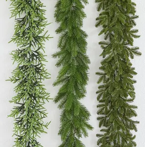 Detailed close-up view of three different varieties of artificial green Christmas garlands