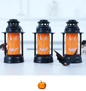 Three orange Halloween pumpkin face lanterns with black frames for party atmosphere