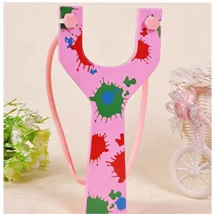 Detail macro view of a pink slingshot with vibrant colorful splatter paint design