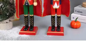 Detail showing wooden nutcracker soldier legs on a red square base with festive decor