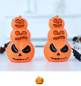 Close-up view of 3-tier Halloween pumpkin glowing lanterns with metal hanging rings