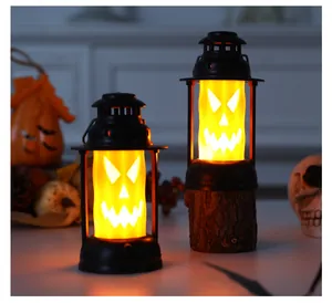 Close-up of atmospheric glowing Halloween kerosene lanterns in two sizes for spooky decor