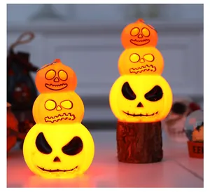 Detail view of 3-layer glowing Halloween pumpkin ornaments featuring warm warm LED light