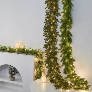 Artificial Christmas pine garland with warm LED lights for festive wall decoration