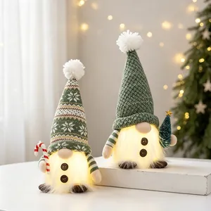 Pair of green knitted Christmas gnomes with warm glowing beards for holiday decor